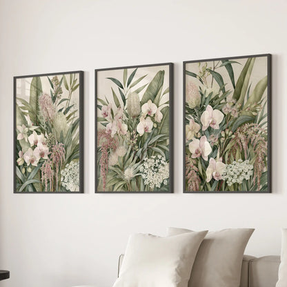 Above a sofa, three black-framed prints show pink orchids among layered green leaves.
