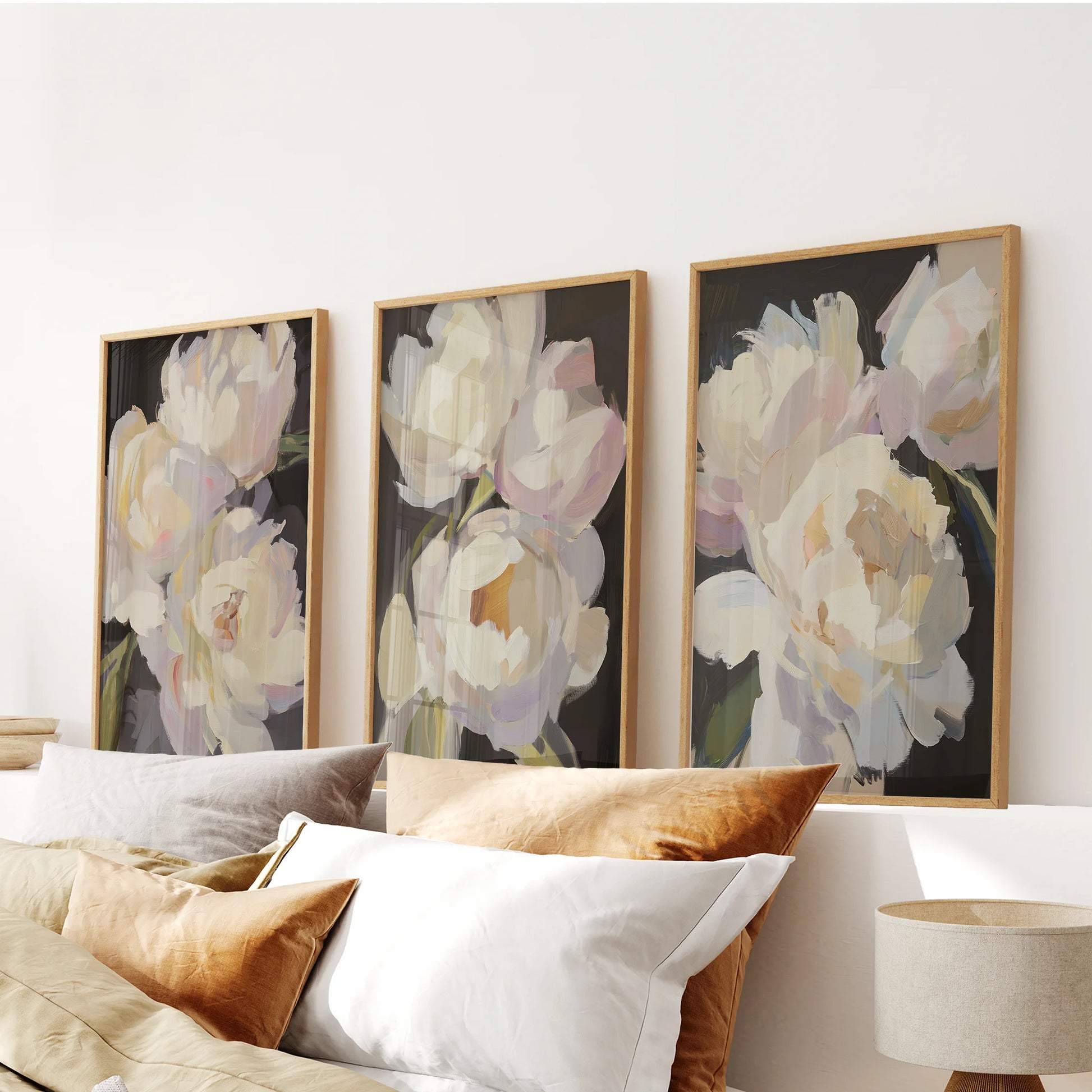 Antique oil flower studies, a set of 3 art prints, center above the bedroom headboard in warm wood frames, layering texture and duskier tones.