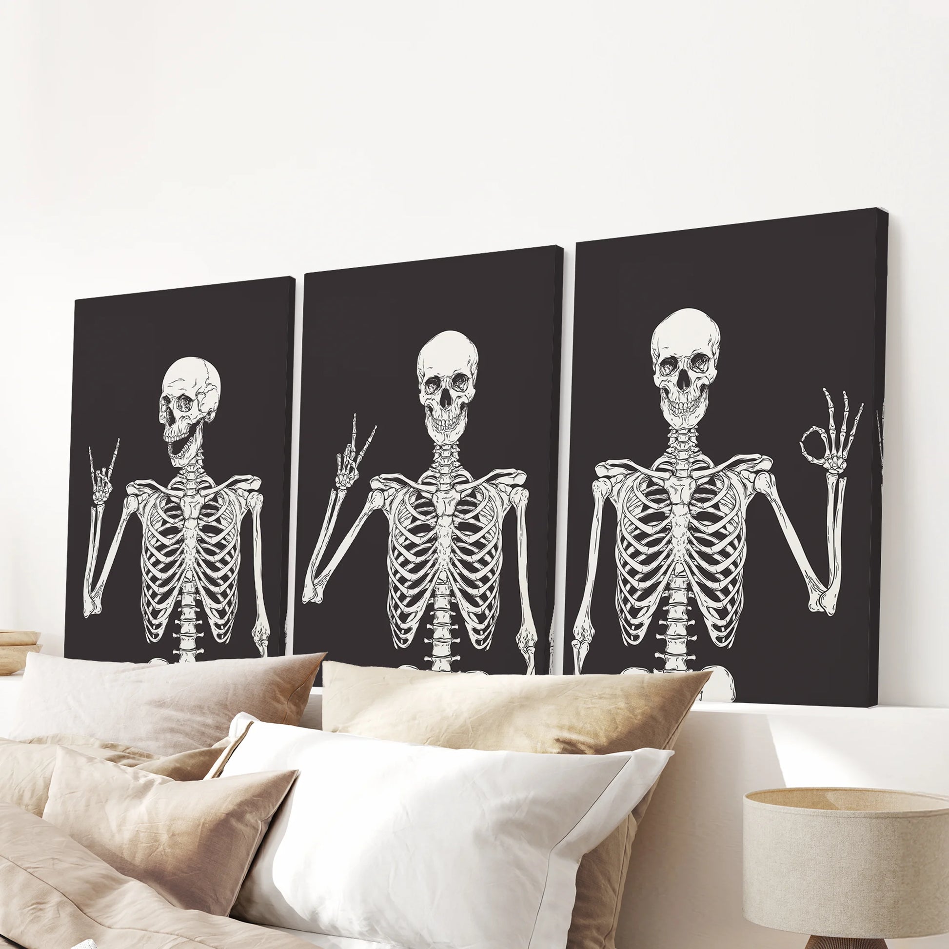 Wrapped canvas prints of a skeleton trio complete the bedroom wall above the bed, finishing the space with a witty Halloween accent.