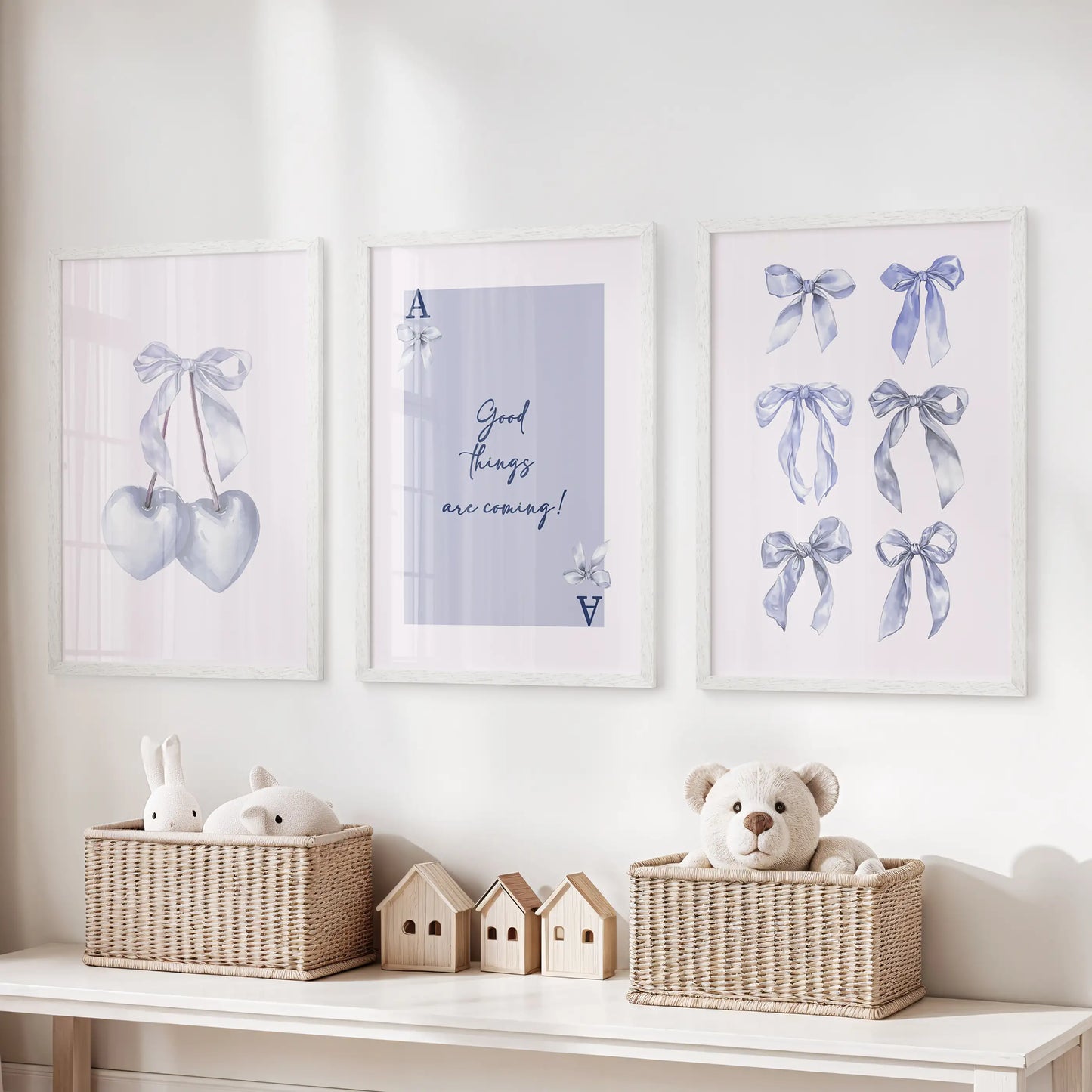 Playing-card heart motifs wall art, three-piece series, arrives as white framed prints to organize the playroom vibe above toy storage in soft light blue.