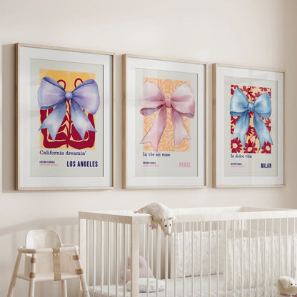 Pastel ribbon bows, three framed art prints with matting, hover above the infant room bassinet, adding a gentle blush of color and calm.