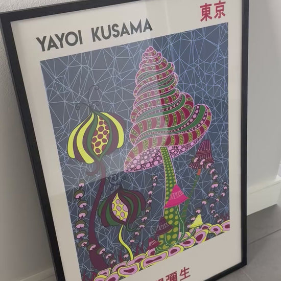 A framed Yayoi Kusama Japanese exhibition print is featured in a customer video review, showing the colorful artwork, black frame and hanging hardware.