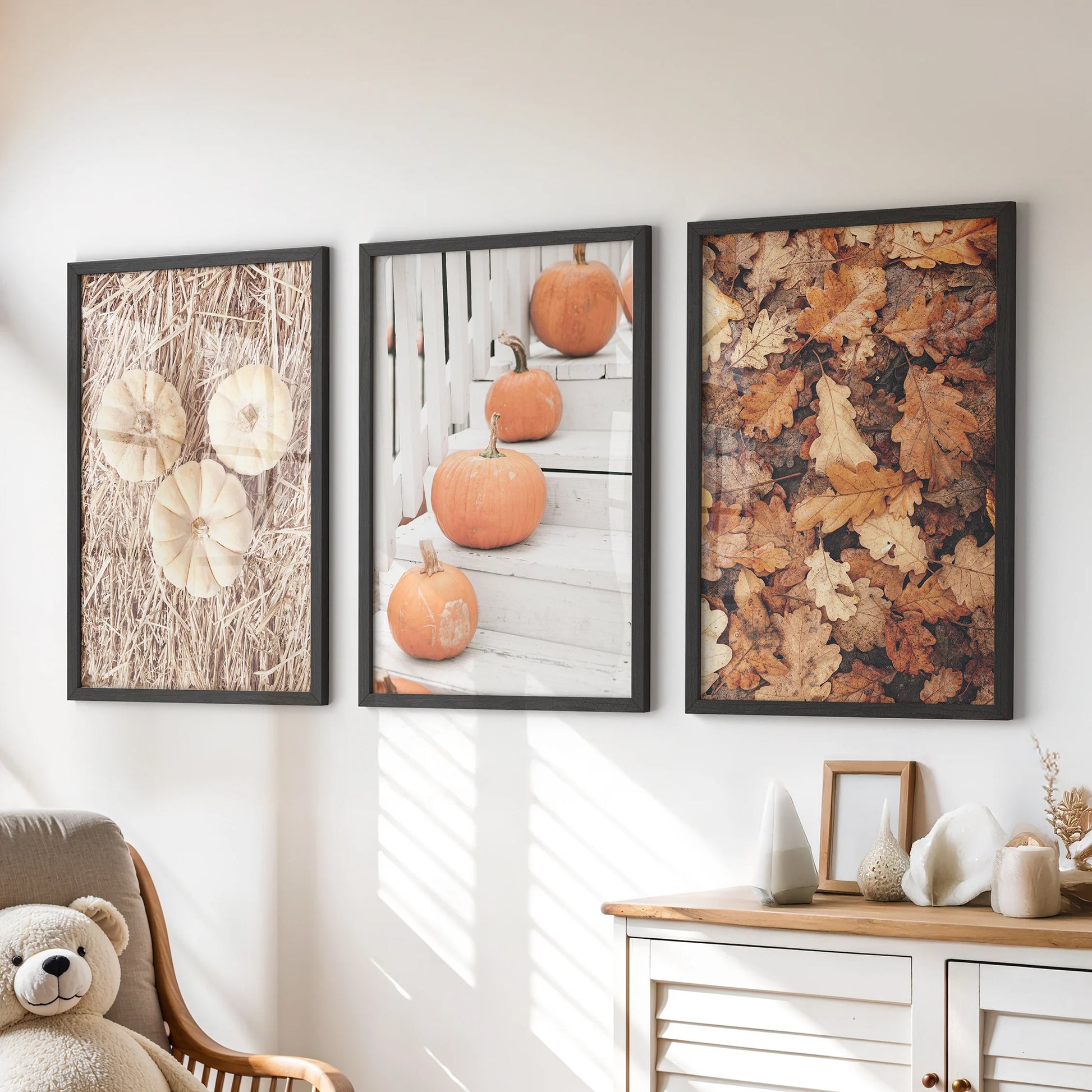 Three playful pumpkin posters in black frames hang above a kids’ dresser, bringing cozy autumn color and farmhouse style to the wall.