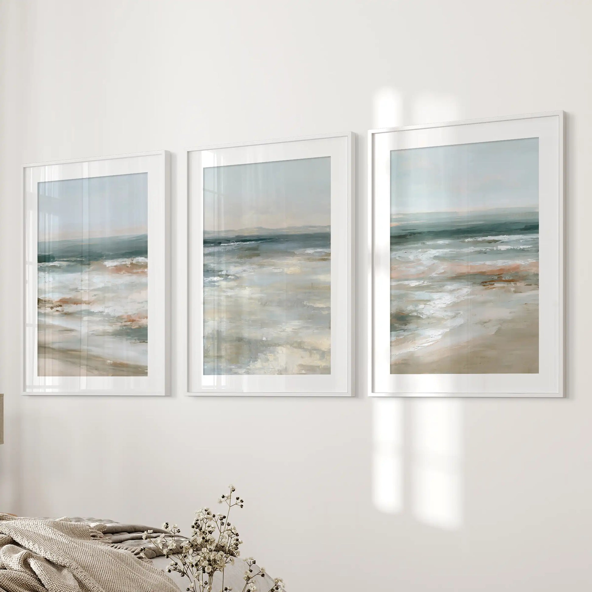 Soft blue seascape set of 3 prints in white mat frames lends gentle wall art near the bed wall, easing the bedroom into a restful coastal vibe.