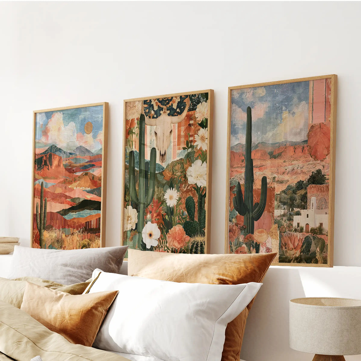 A trio of Western desert landscape artworks above the bedroom bed, thin wood frames outlining distant buttes and big sky in restful hues.