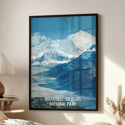 Wrangell-St. Elias National Park standalone artwork, a black-framed wall art print, hangs above a lounge chair in the living room, showcasing icy peaks.