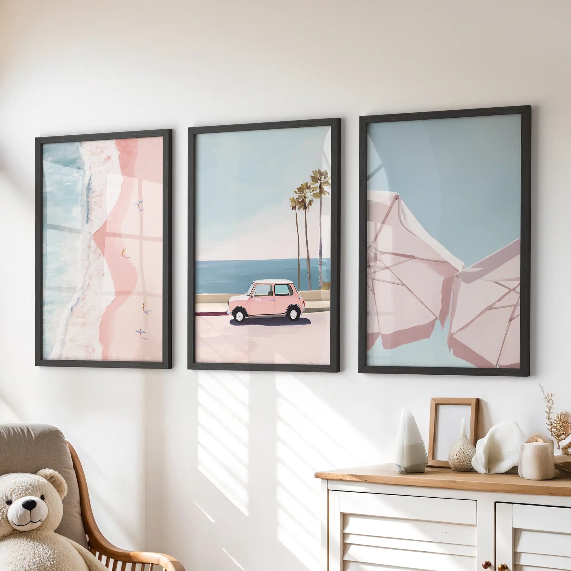 A 3-piece beach print set framed in black adds gentle pastel shoreline tones above the chest of drawers in the kids’ playroom.