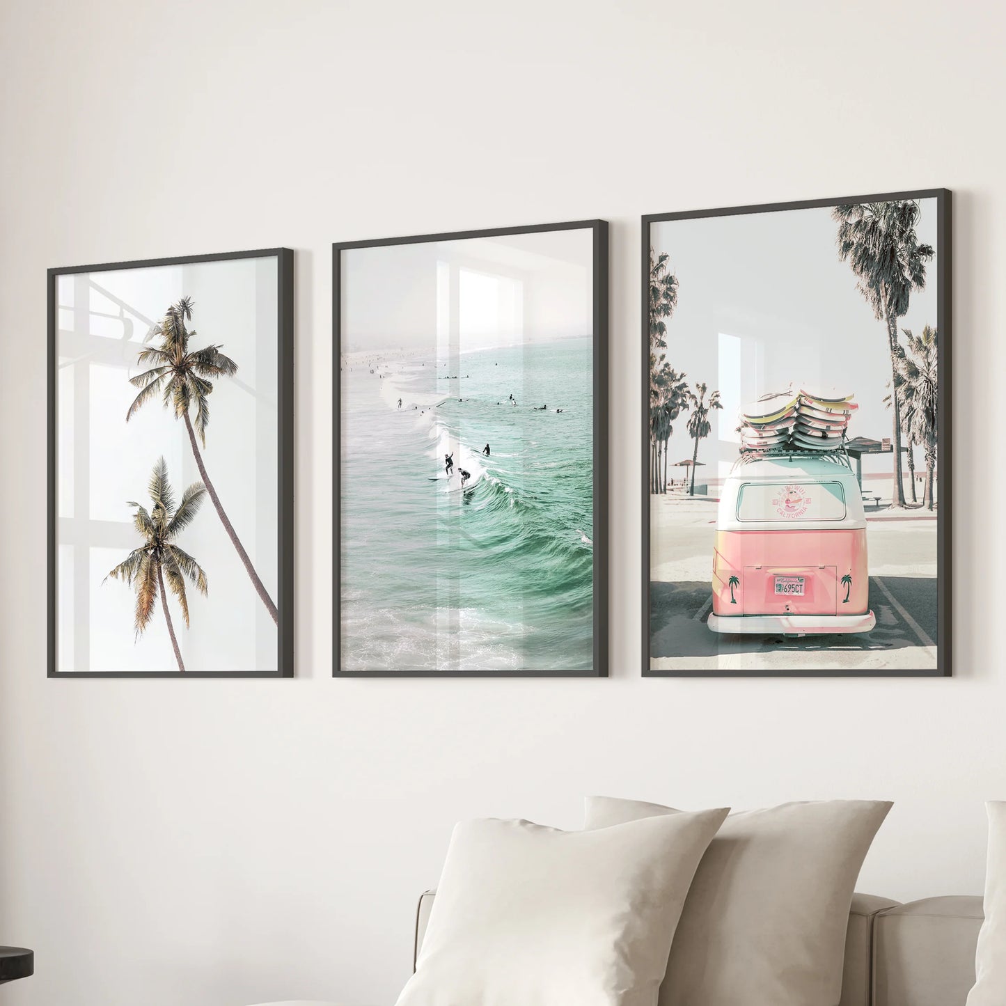 Pink camper van on the beach art triptych brings a sunny focal point over the sectional in the lounge, displayed in sleek black frames.