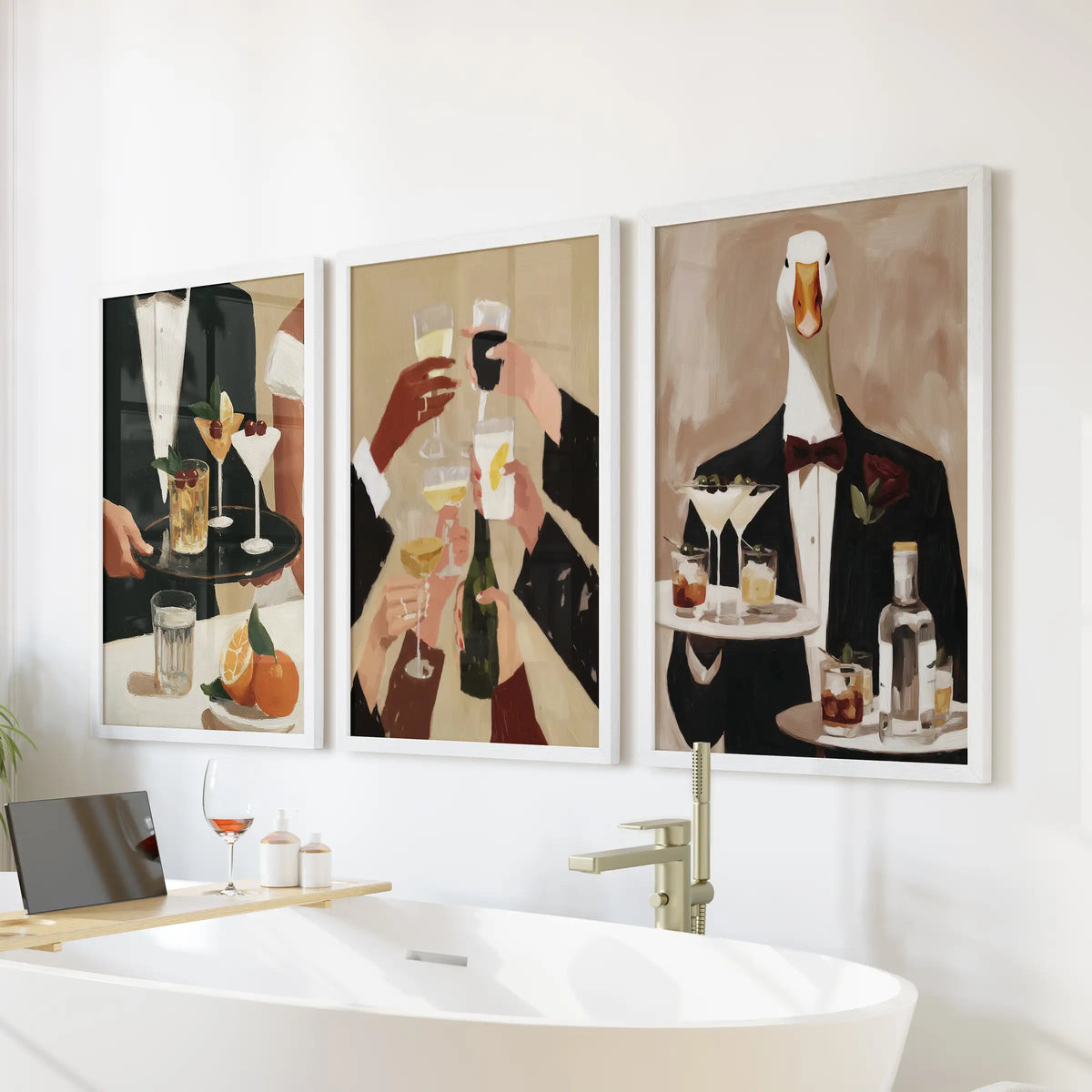 Retro drink illustration wall art in a poster trio, displayed in white frames on the bathroom wall over the tub.