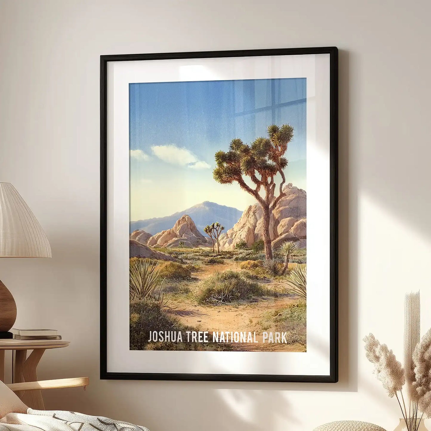 Single-panel Mojave Desert travel art print in a black frame with matting adds a crisp, nostalgic feel above the window-side chair in the family room.
