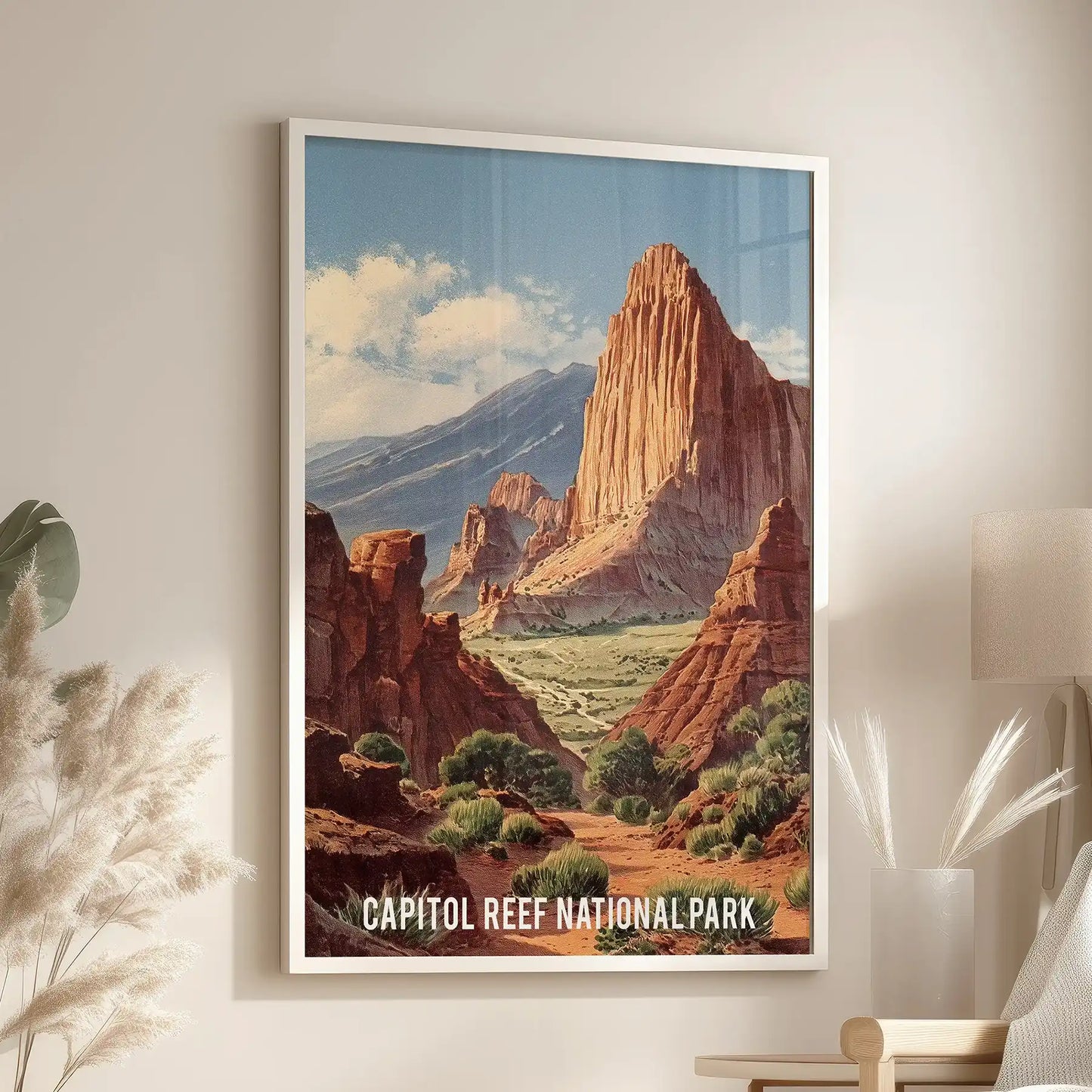 White-framed retro travel poster wall art of Capitol Reef hangs above a living-room accent chair, bringing nostalgic, graphic character.