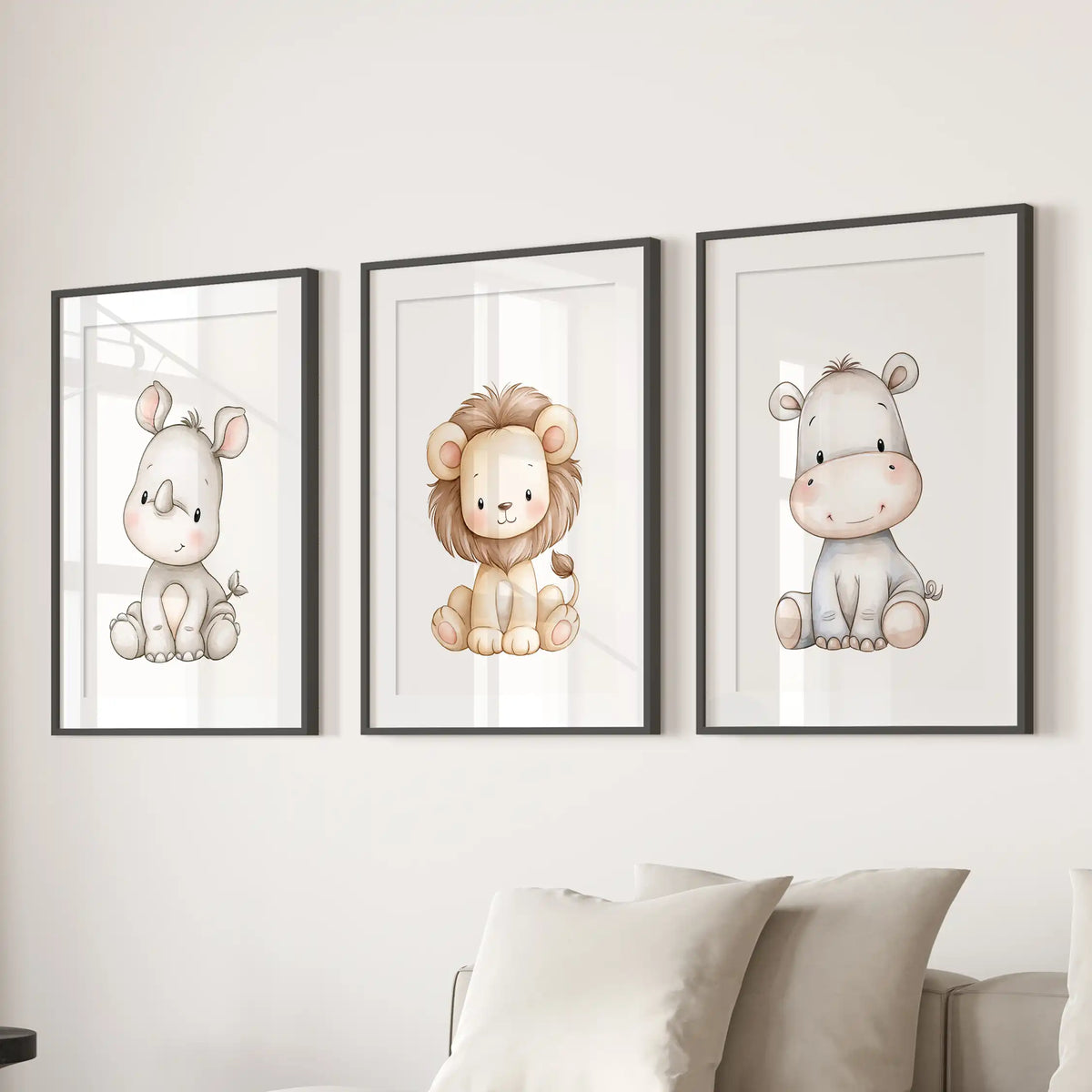 Black frames with white mats surround three prints above a sofa, showing a baby rhino, a lion with a golden mane and a gray hippo.