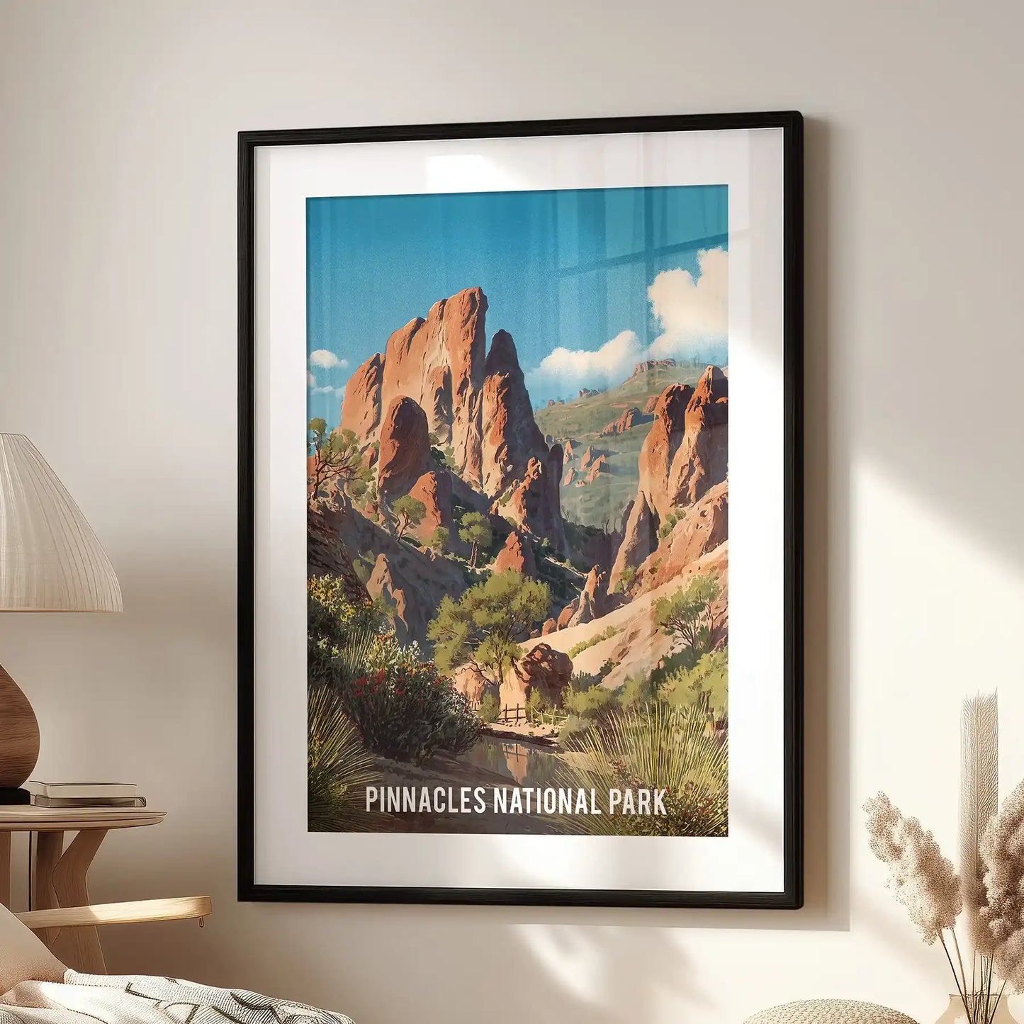 A black-matted framed print illustrating desert canyon formations hangs above a lounge seat, adding texture and depth to a family room setting.