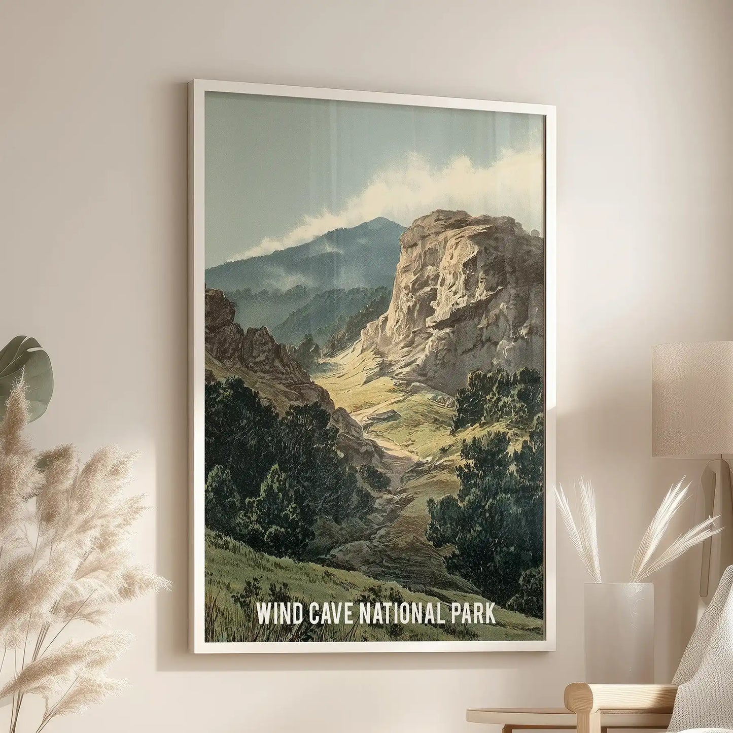 Moody earth-tone wilderness statement poster in a crisp white framed print settles into the lounge, hanging over a cozy chair for a calm, adventurous look.