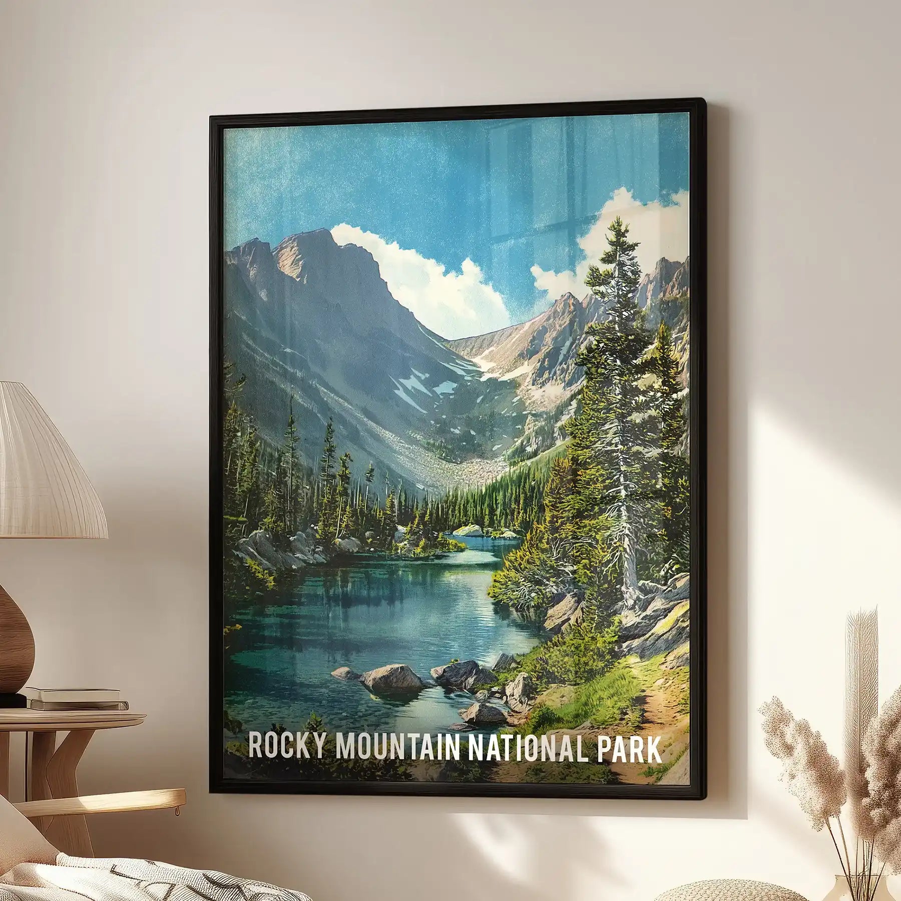 A black-framed landscape print of Rocky Mountain National Park hangs above a cozy chair, bringing alpine light and warmth to the family room.