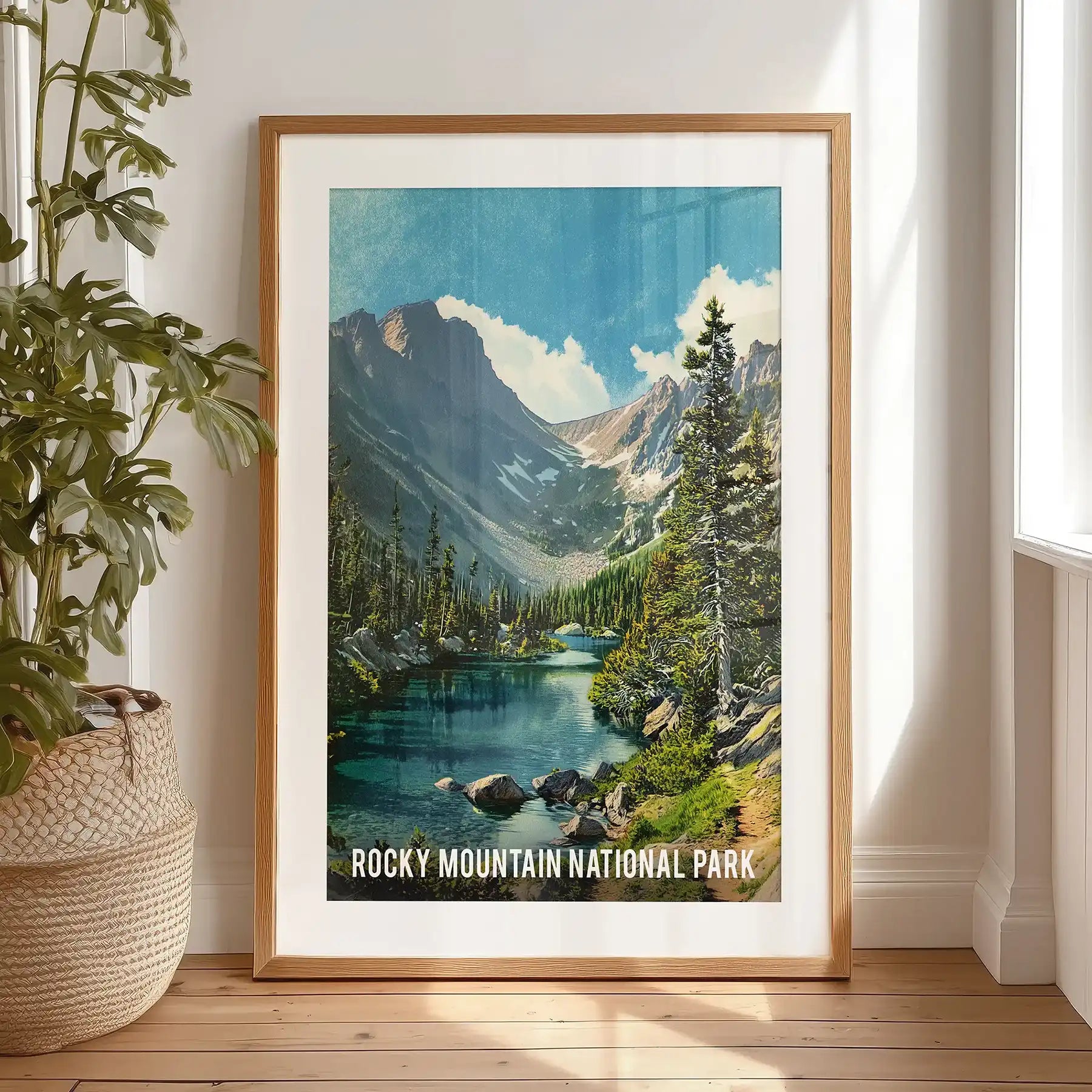 This single travel poster of snow-capped peaks, set in a black-matted frame, leans by the bedroom window for art-studio charm and quiet drama.