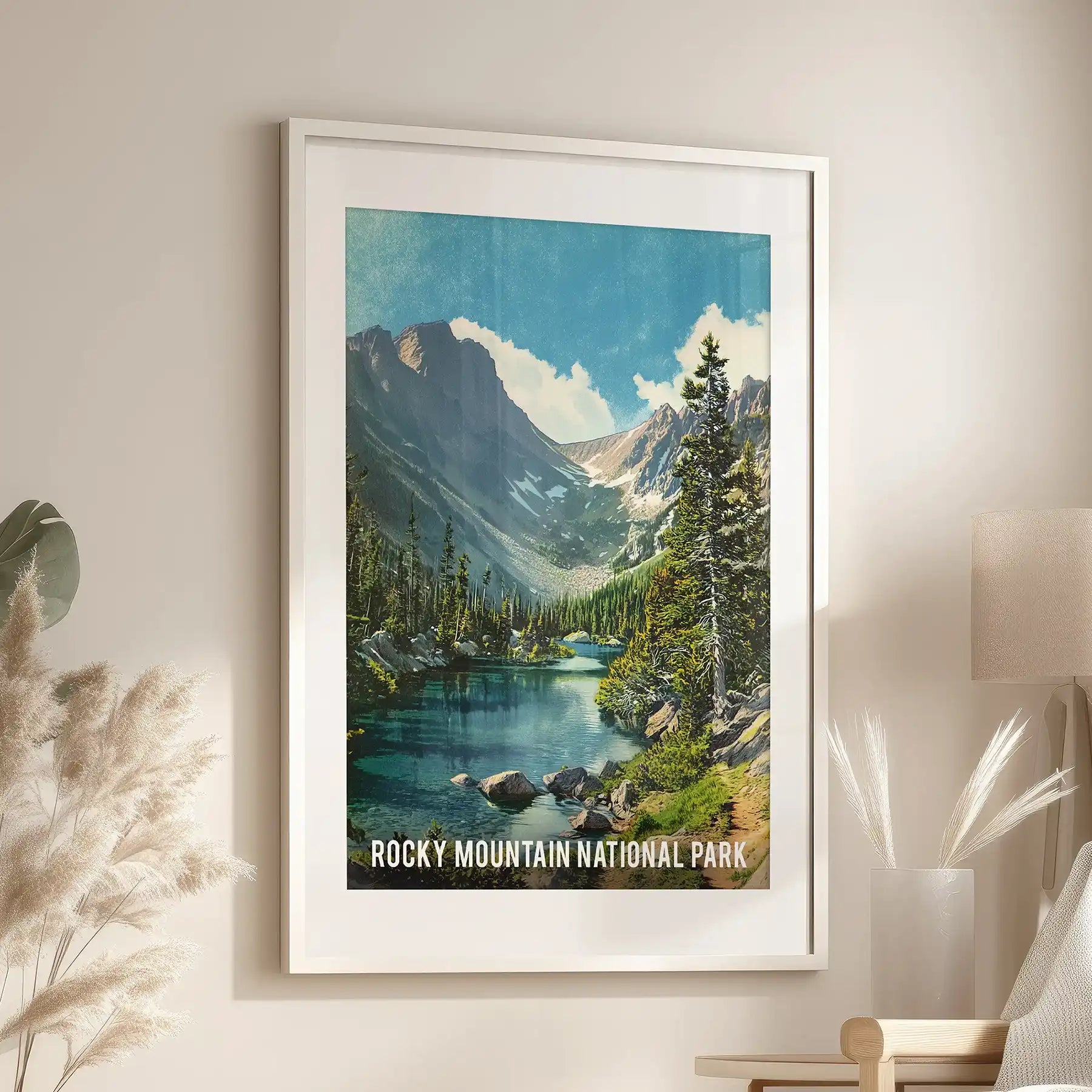 Beside the reading chair, a retro national park travel poster in a white-matted frame lends the lounge an easy sense of wanderlust and history.