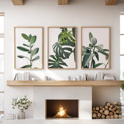 A trio of oak-framed leaf prints gives the family room wall art a grounded, earthy presence above the mantel.