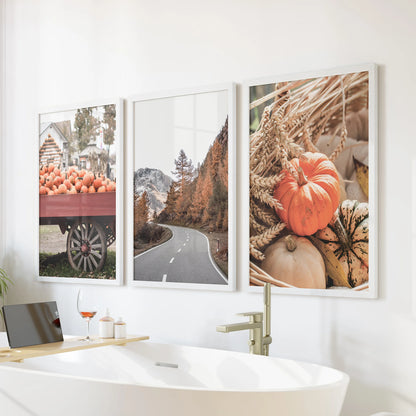 Rustic countryside scene framed poster triptych turns the bathroom serene, white frames lined up over the bath to echo soft hills and quiet fields.