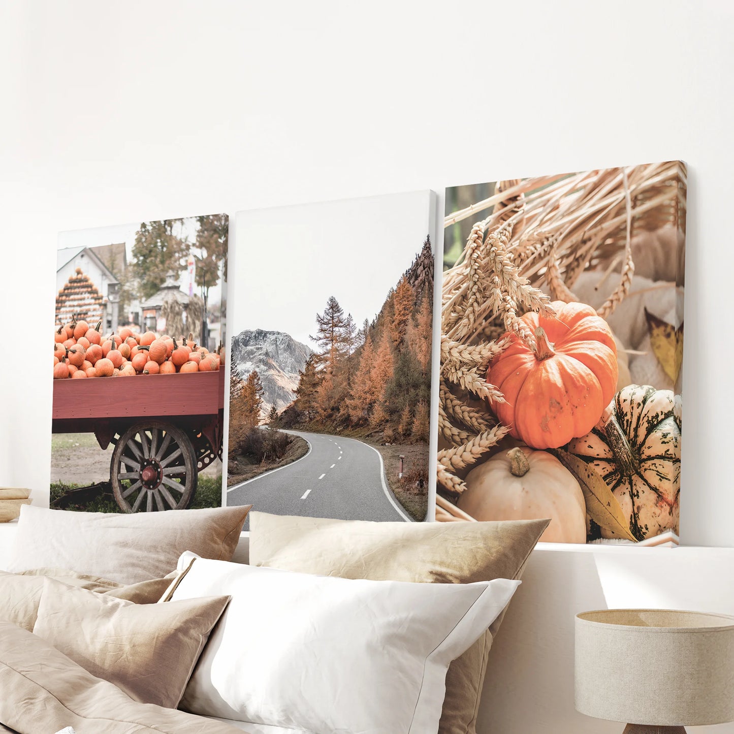 Rustic countryside landscape set of three ready-to-hang canvases anchors the bedroom above the headboard, textured prints with soft, golden fields.
