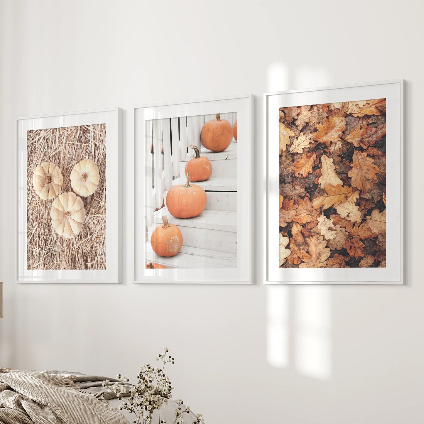 A gallery set of three white-matted pumpkin photos brightens the bedroom wall with crisp stems, soft textures, and subdued fall hues.