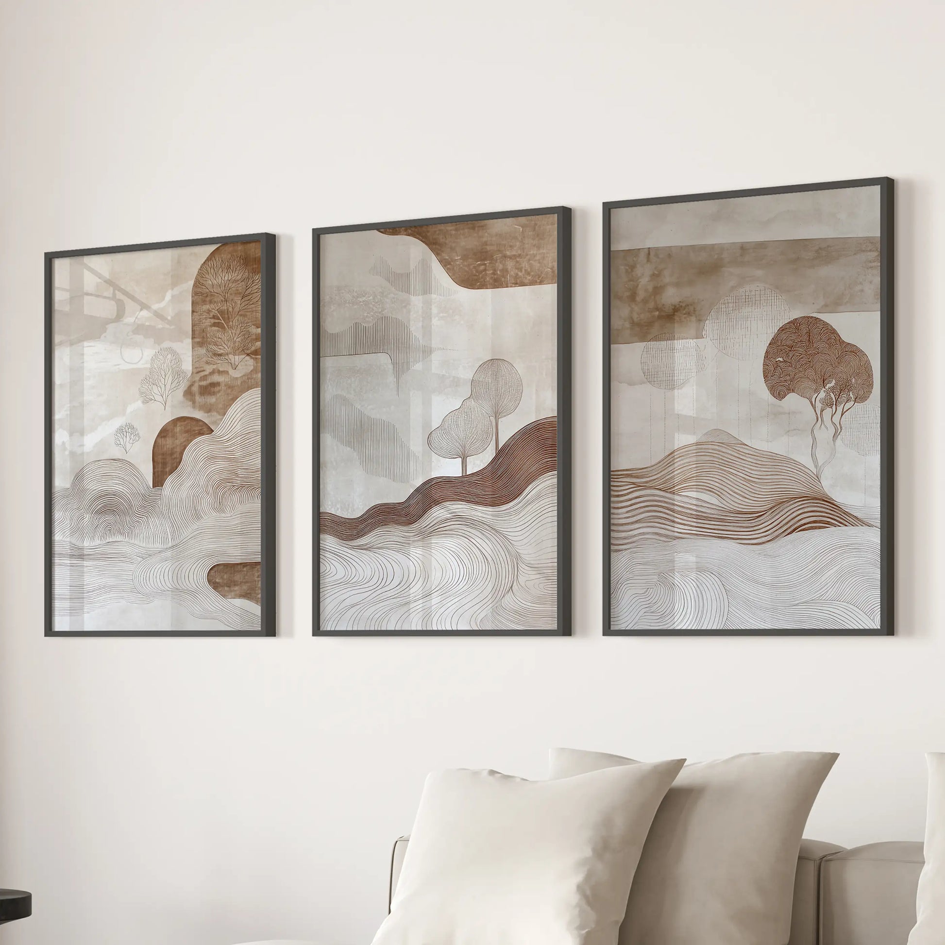 Neutral abstract shapes triptych wall art, in sleek black frames, centers the family room behind the couch with layered beige and brown tones.