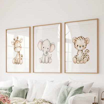 The three animal prints above a sofa show a giraffe, elephant and spotted leopard, surrounded by white mats and oak frames.