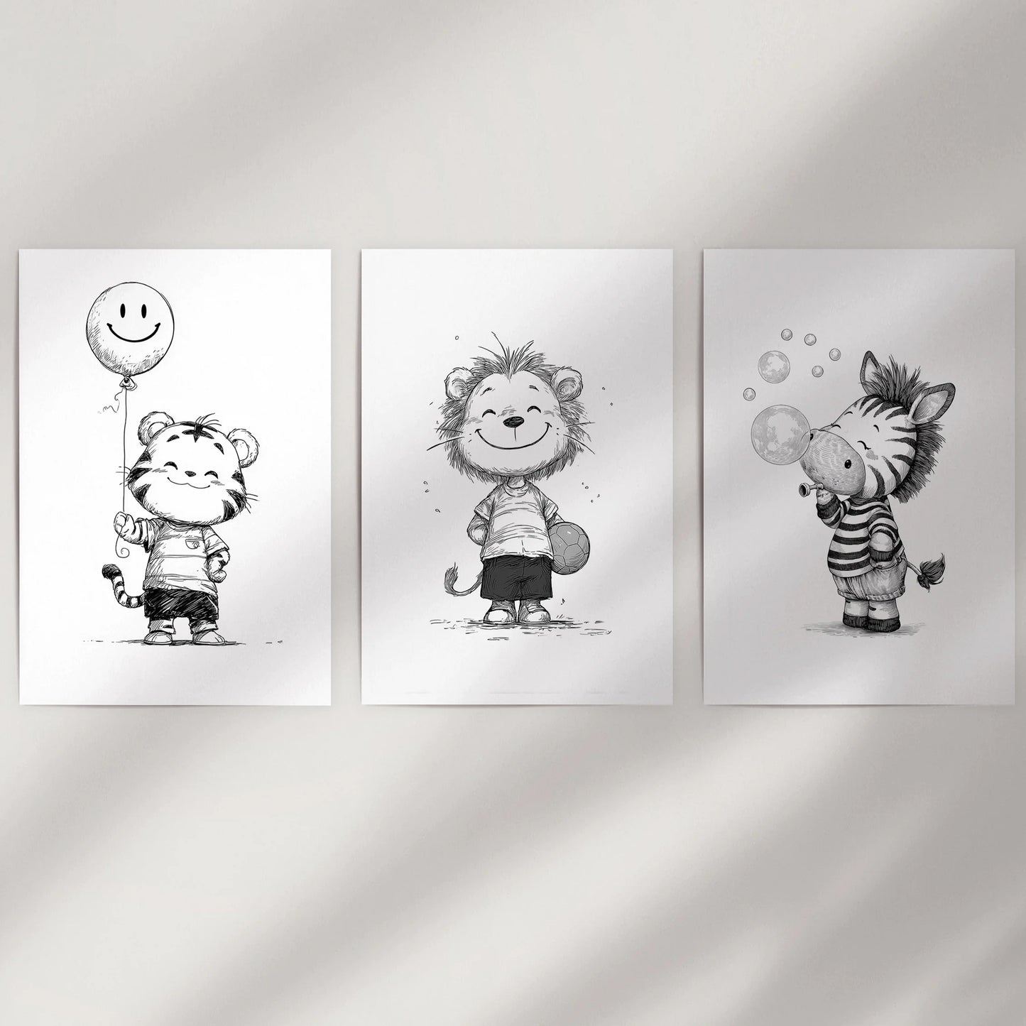 A soft 3-piece gallery wall of unmounted baby animal prints rests on a neutral wall, creating a calm, minimalist look for a nursery or gentle space.