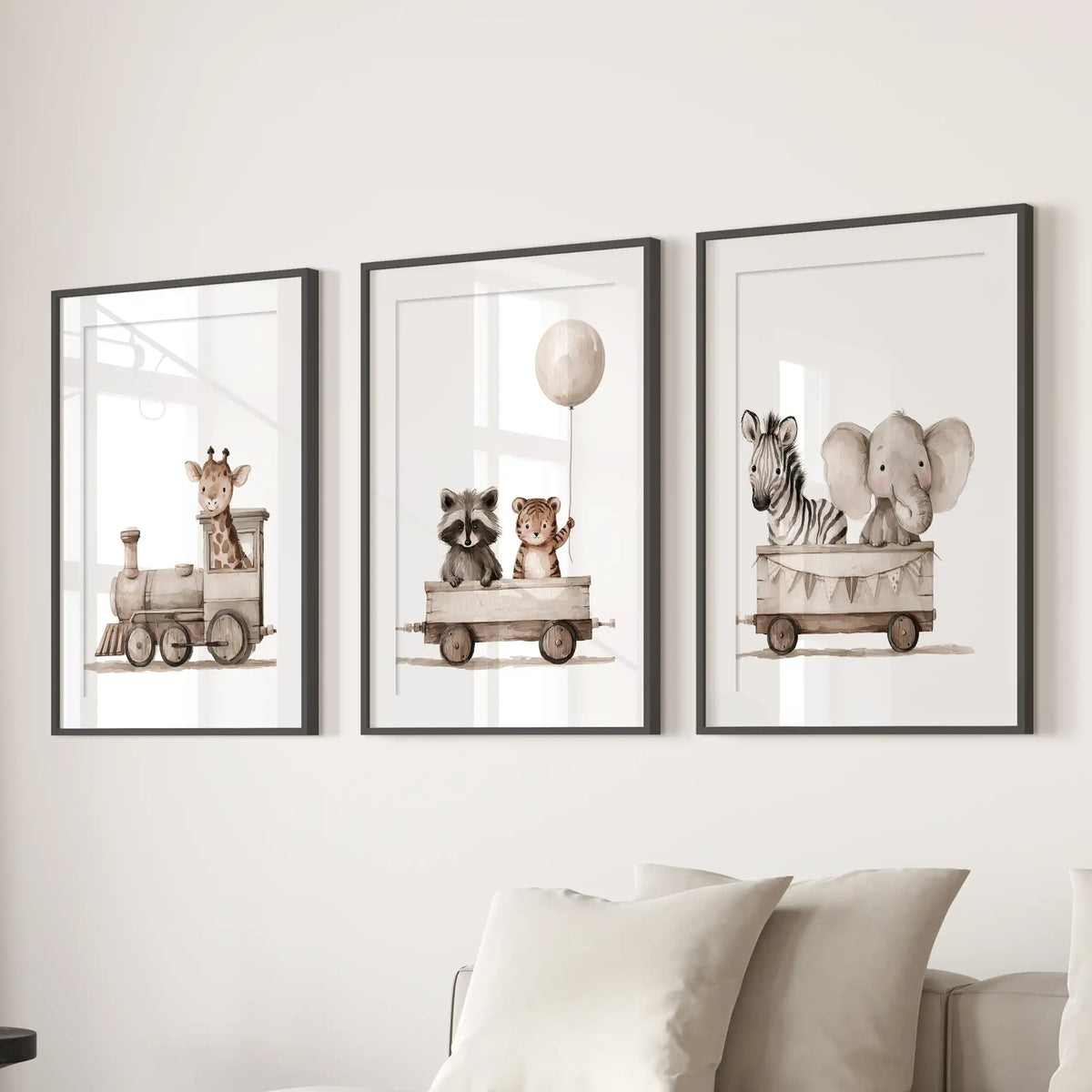 A giraffe rides in the engine, followed by two cars of baby animals, across three prints in black frames with white mats above a sofa.