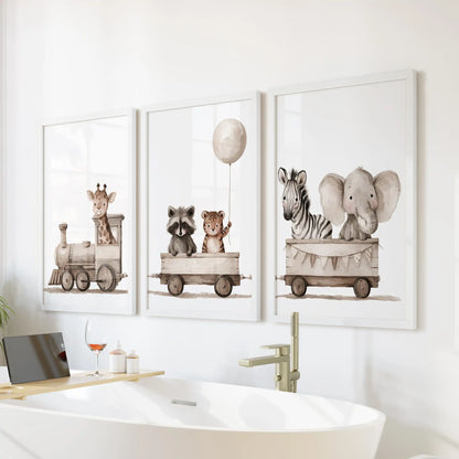 Baby animals occupy a wooden toy train across three white-framed prints above a bathtub, with a balloon over the middle car.