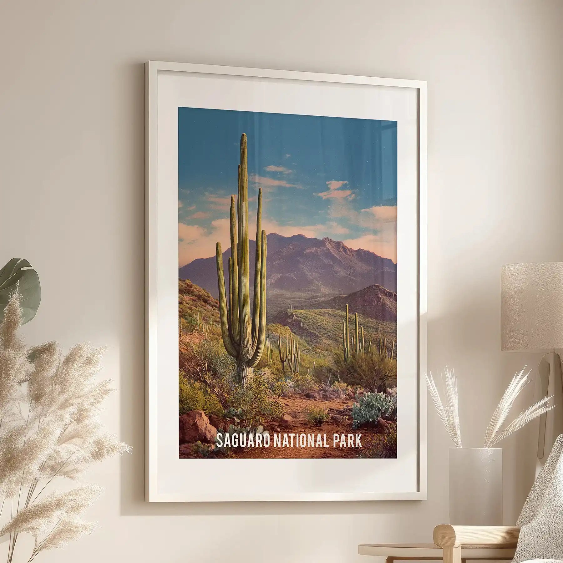 A vintage-style travel poster print, matted and white-framed, centers the family room above the seating area with easy retro character.