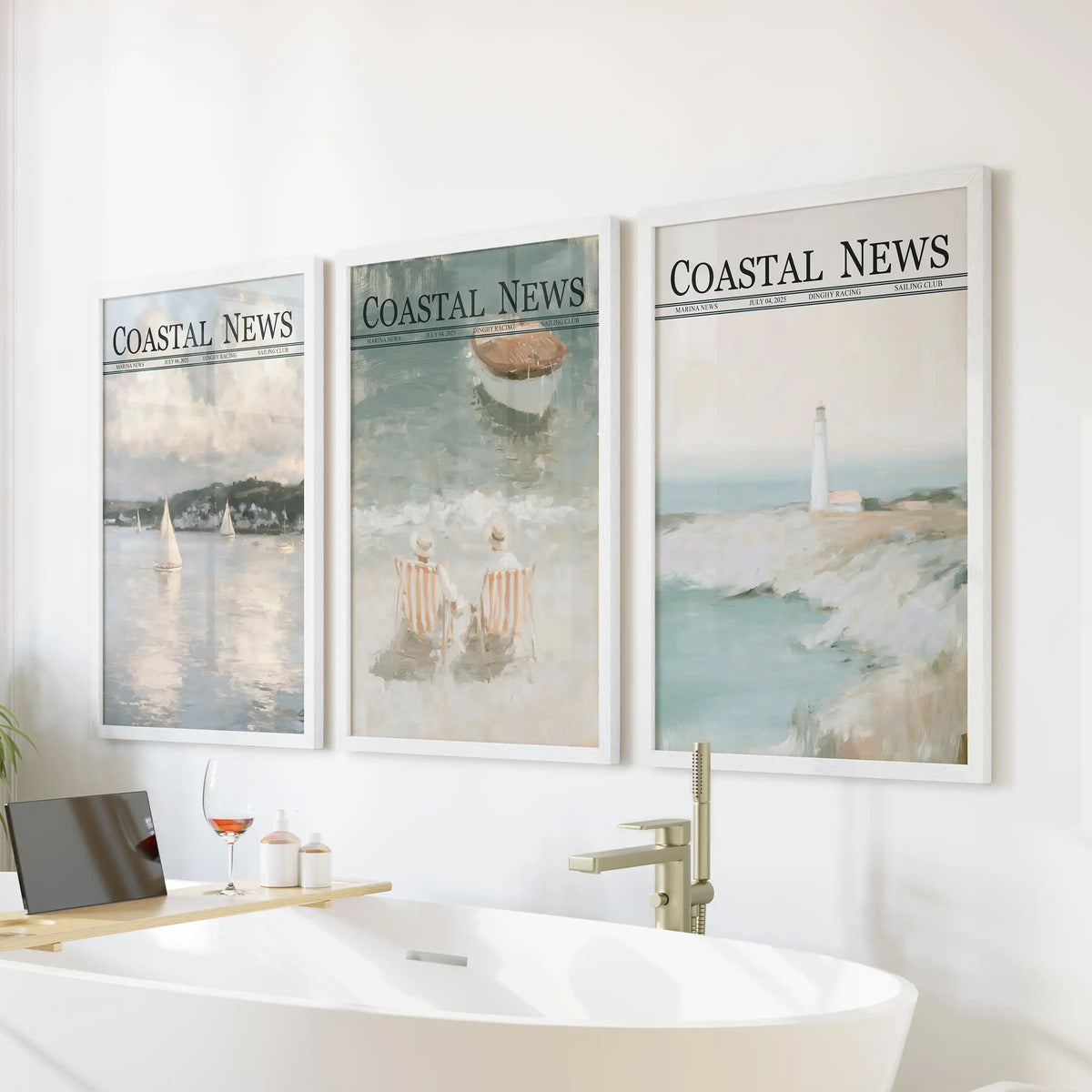 Coastal landscapes make up a wall art set of 3 in white frames, displayed over a freestanding tub in a bathroom.