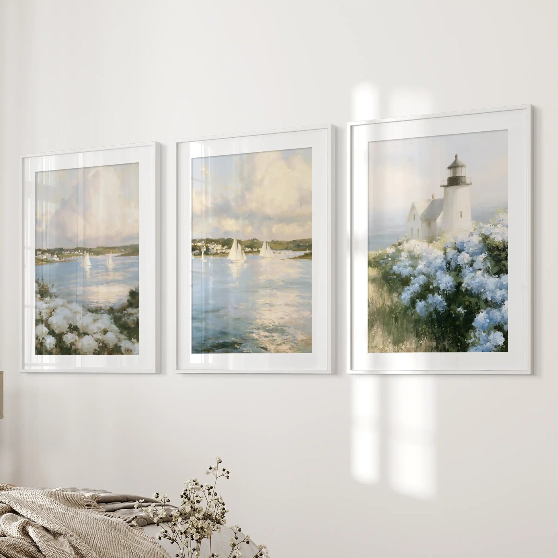 Blue and white hydrangeas gallery wall set of three, in white-matted frames, lends a fresh coastal note to the bedroom wall beside the bed.