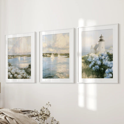 Blue and white hydrangeas gallery wall set of three, in white-matted frames, lends a fresh coastal note to the bedroom wall beside the bed.