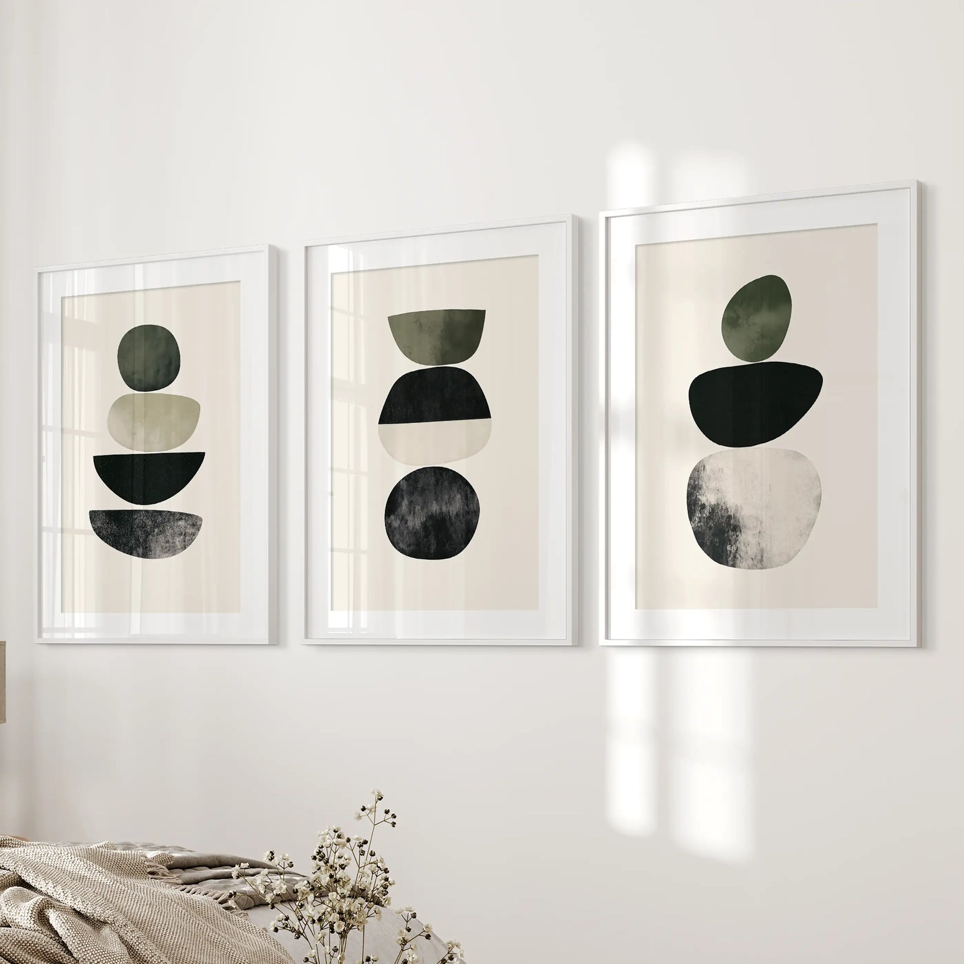 A 3-piece Scandinavian abstract print set, white framed with matting, adds tailored symmetry beside the bed on a softly toned wall.