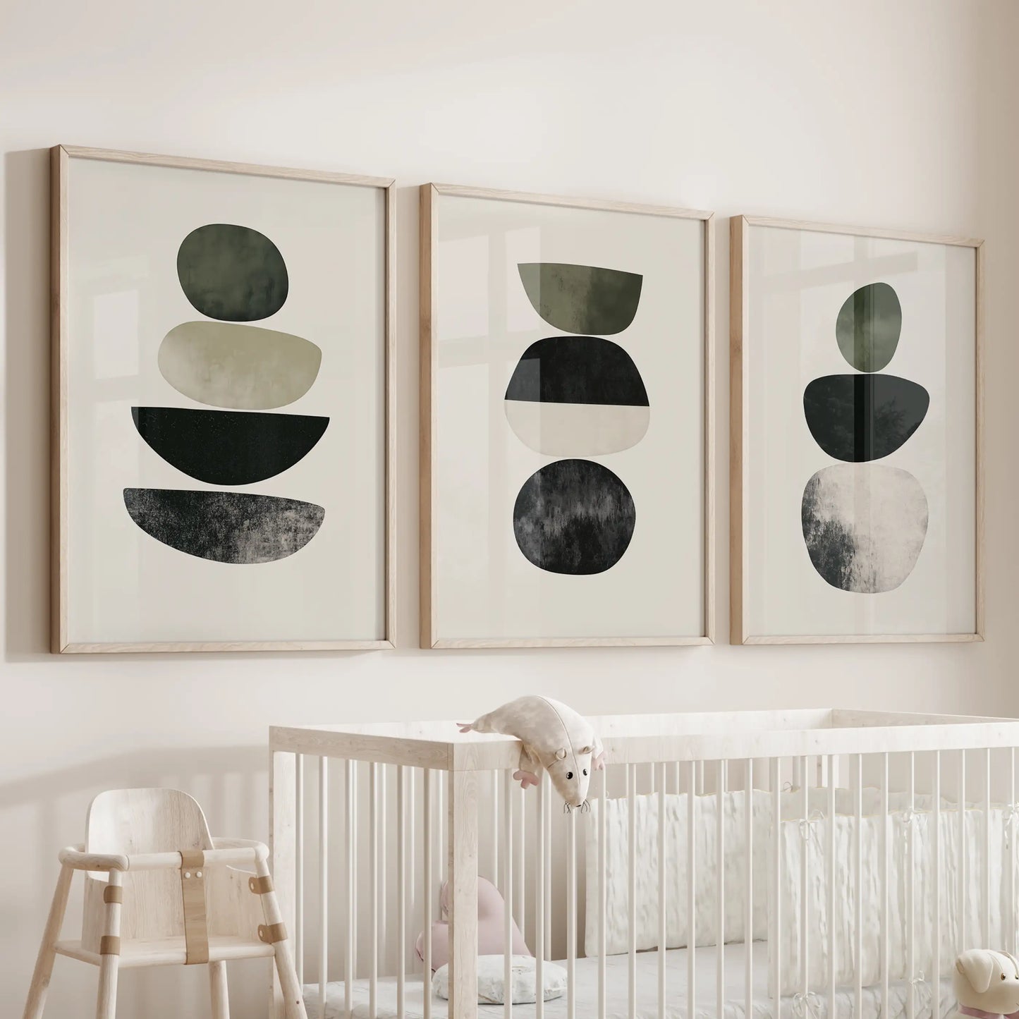 Three oak-framed Scandinavian abstract posters float softly above the crib, giving the nursery a calm, modern center.