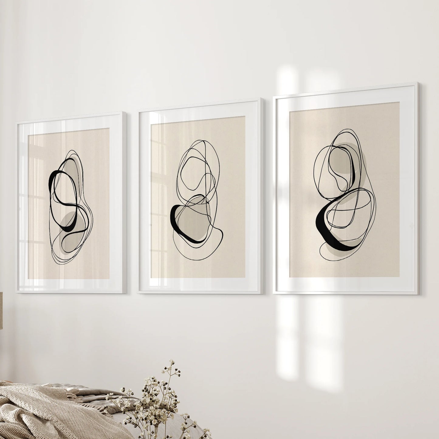 Three white-matted line drawings framed for clean simplicity, forming a serene bedroom gallery with effortless Scandinavian calm.