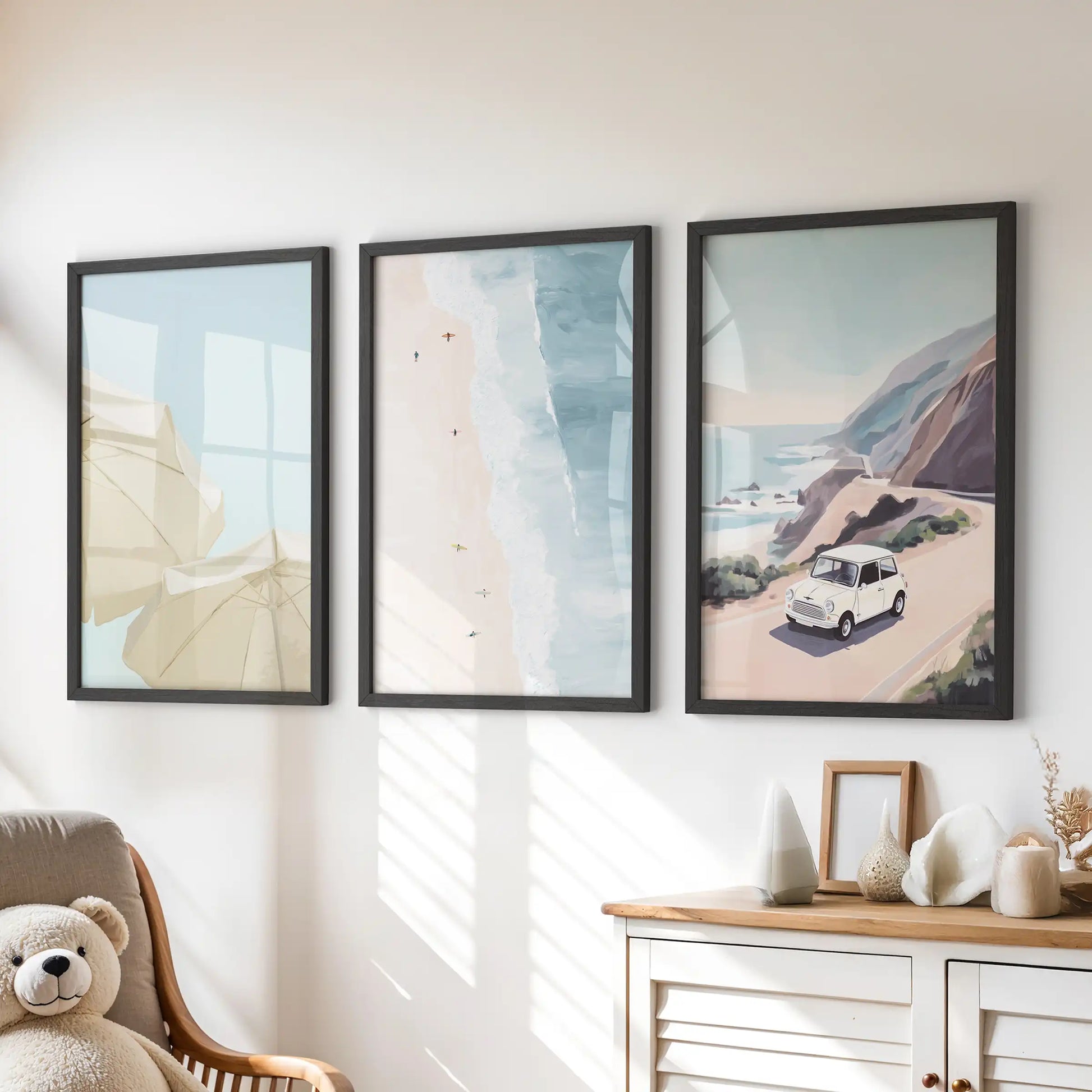 Pastel seaside landscapes wall decor, three-piece set in black frames, brings a calm splash to a children’s room above the chest of drawers.