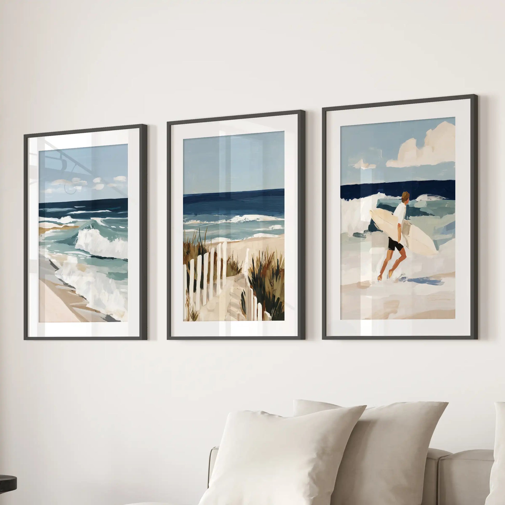 Surfer art prints, set of three, bring coastal energy to the living room in black matted frames, lined up as a clean statement over the couch.