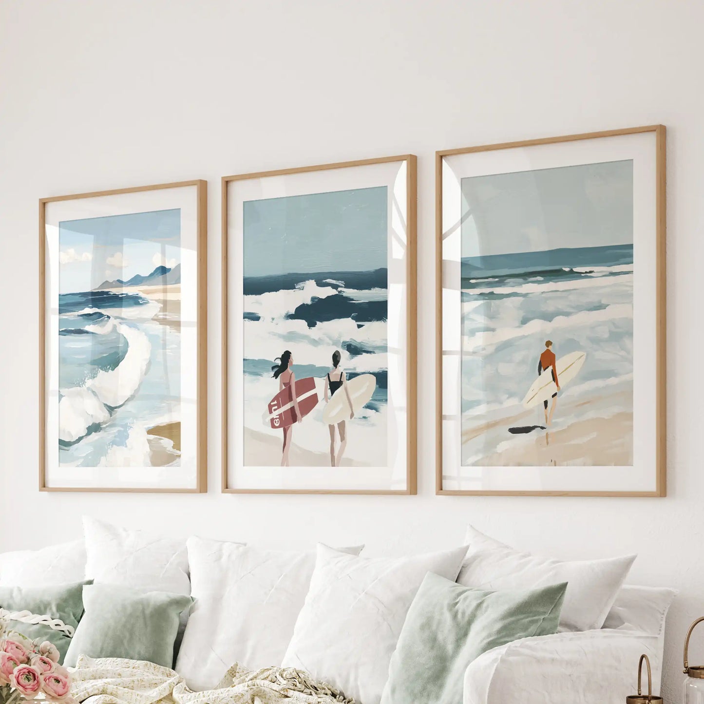 An oak-framed wall art trio showing ocean waves hangs over the sectional, infusing the lounge with smooth coastal calm.