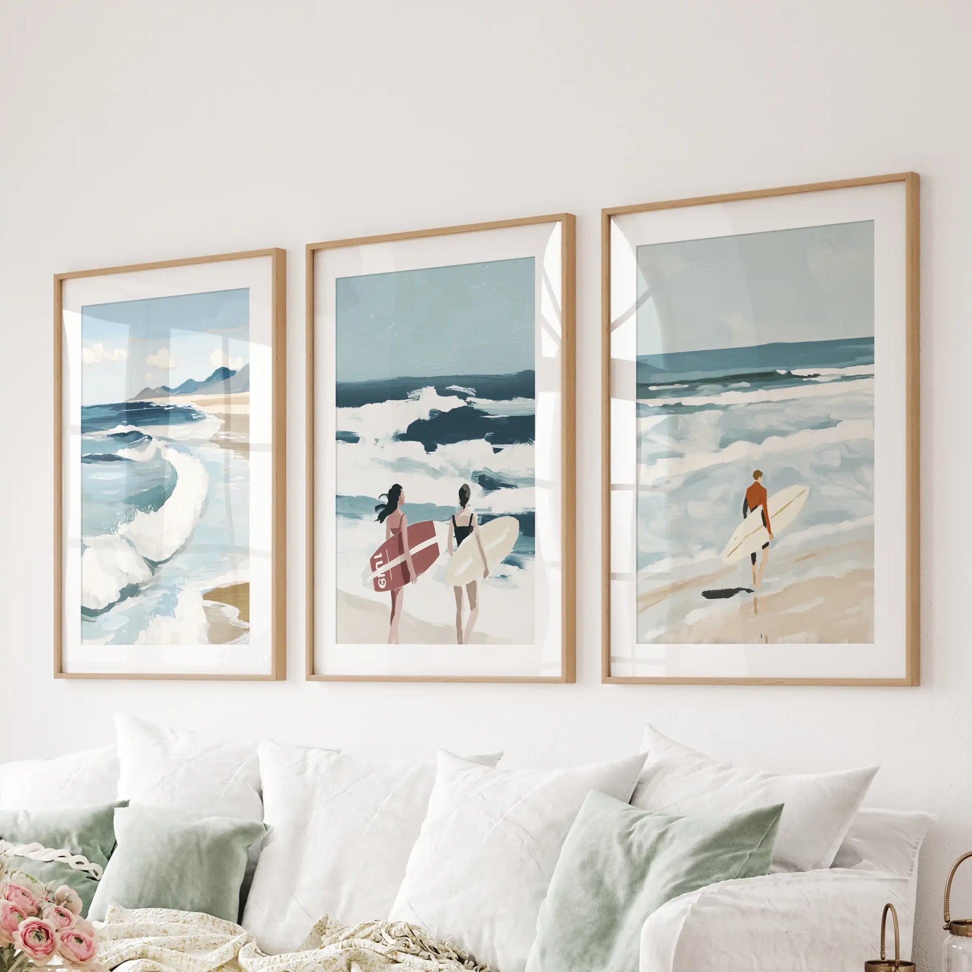 An oak-framed wall art trio showing ocean waves hangs over the sectional, infusing the lounge with smooth coastal calm.