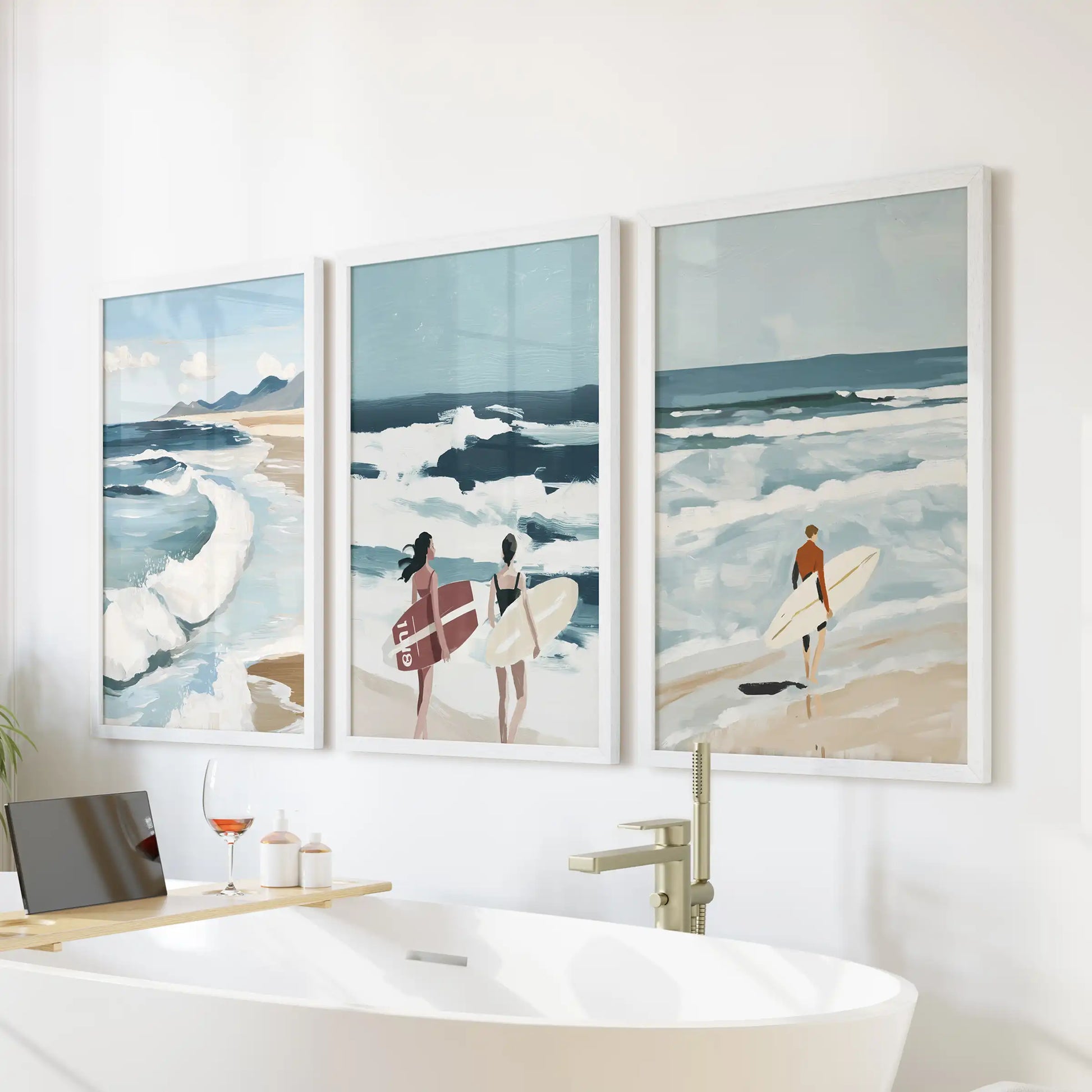 Breaking wave detail three-print set in white frames, arranged over the tub wall to bring spa-like ease to a modern bathroom.