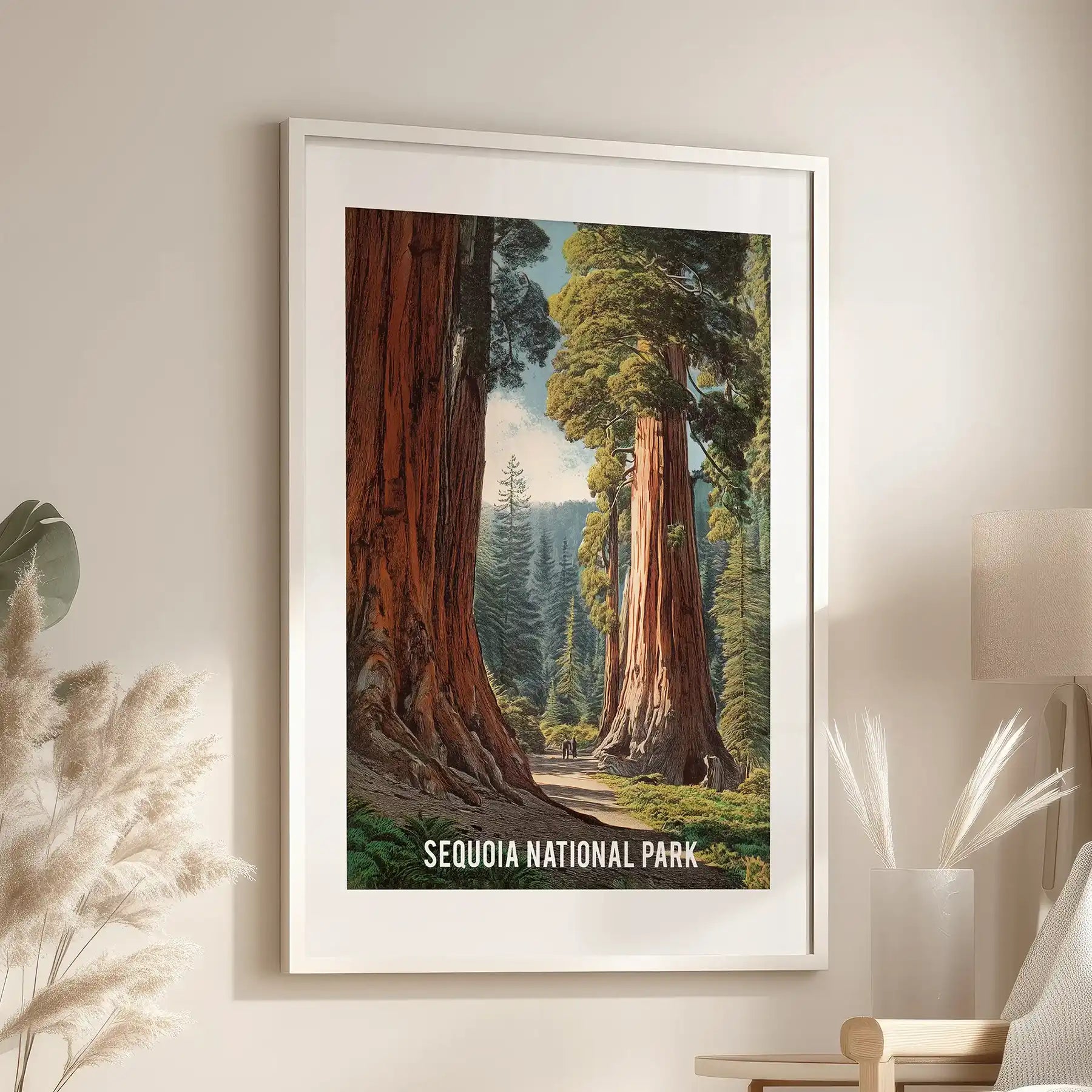 Wall art print of a redwood grove in a white frame with matting hangs above an armchair, showing tall trunks in soft, earthy tones.