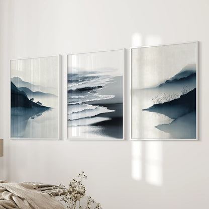 A trio of navy ocean prints in bright white frames leans neatly by the bedroom wall beside the bed, freshening the space.
