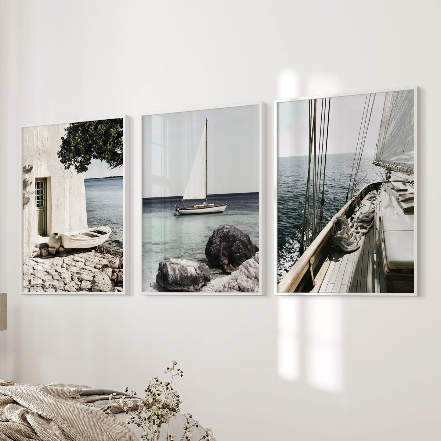 Riviera coastline posters, set of 3, come in white frames and grace the wall next to the bed, adding a tranquil coastal note to the bedroom.