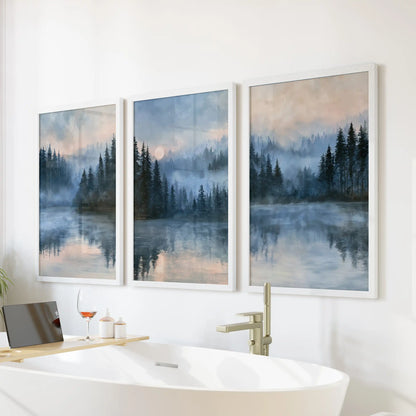 Three-piece impressionist woodland artwork in crisp white frames hangs above the bathtub, bringing dreamy pines and hushed blues to the bathroom.