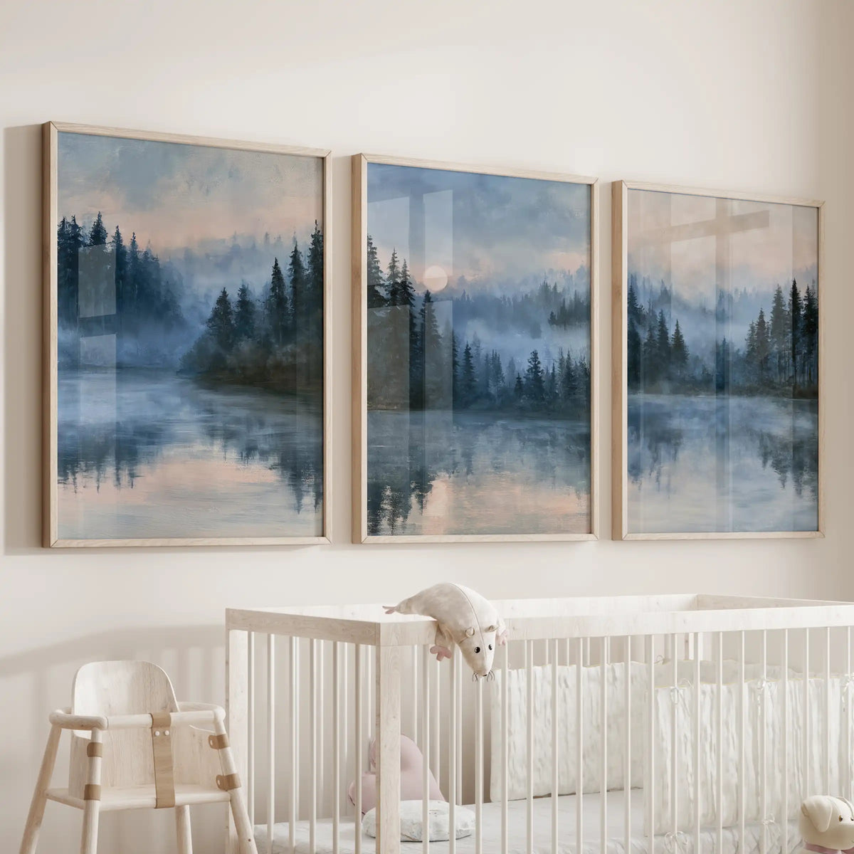 Pine forest wall prints create a three-piece gallery in slim wood frames over the crib, adding soft mist, tall evergreens, and a woodland hush.