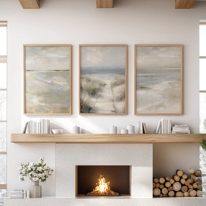 Oak-framed wall art in three panels captures dune grass shorelines and warms the living room wall above the fireplace.