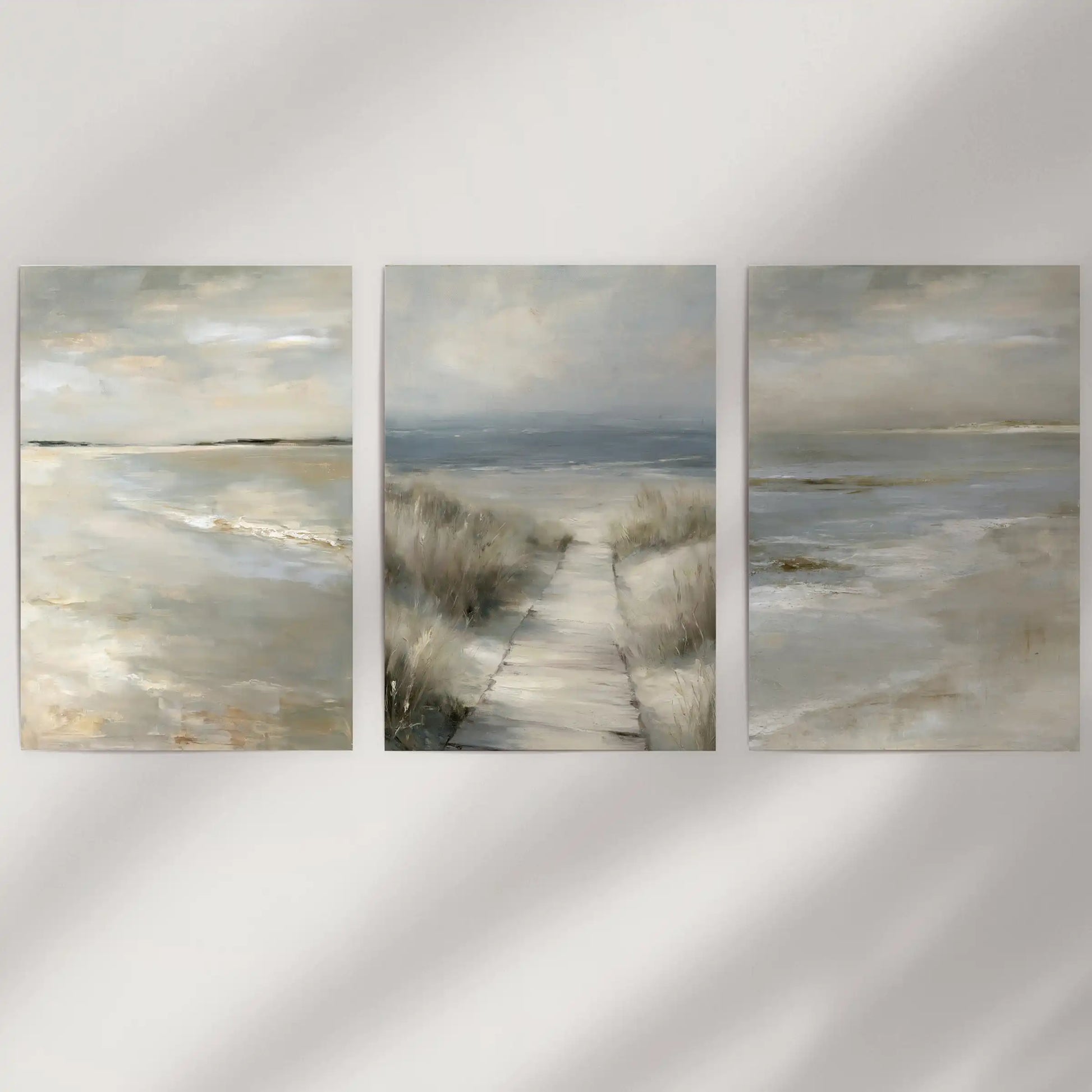 Unframed wall art prints with neutral coastal landscapes, a set of three, keep a minimal warmth across an open blank wall.