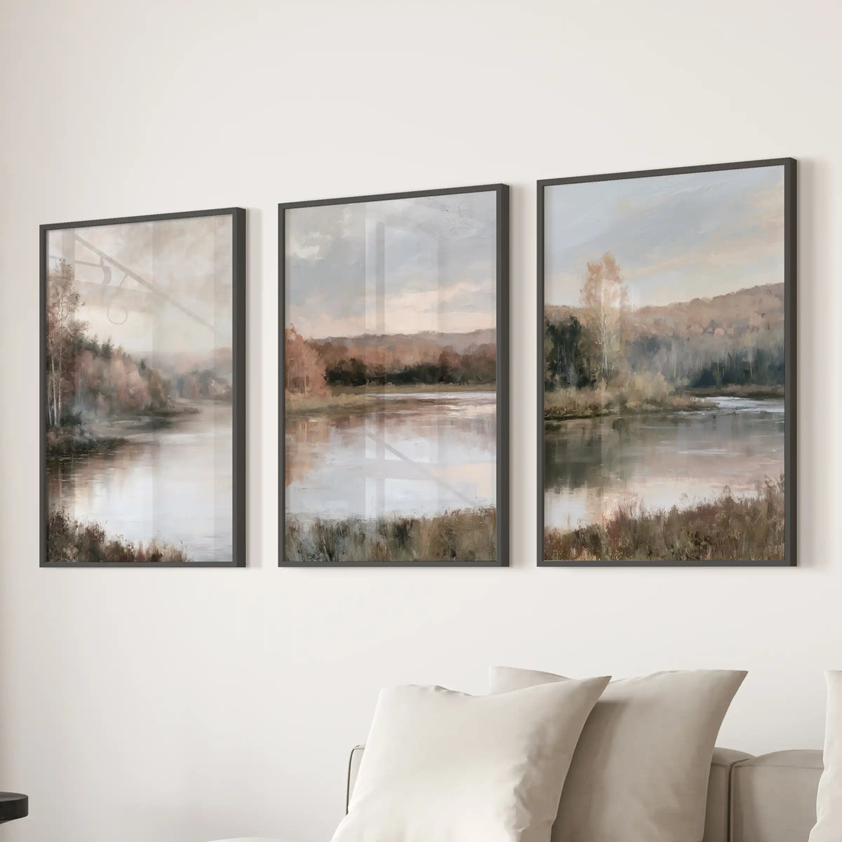 This three-piece wall art of soft impressionist fall vistas glows gently above the living room sofa, finished in sleek black frames.